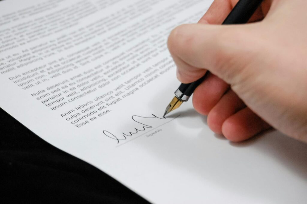 Person signing a legal document like a company formation